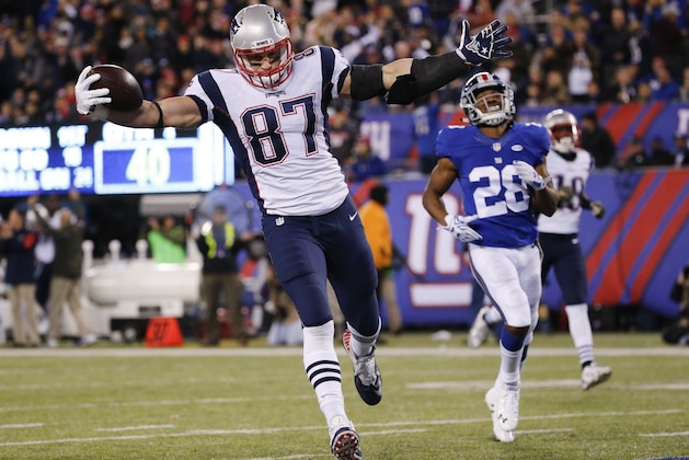New England Patriots' Rob Gronkowski (87) scores a touchdown in front of New York Giants' Jayron Hosley (28) during the second half of an NFL football game, Sunday Nov. 15, 2015, in East Rutherford, N.J. (AP Photo/Julio Cortez)