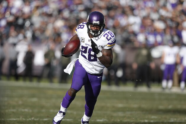 Minnesota Vikings running back Adrian Peterson (28) runs against the Oakland Raiders during the first half of an NFL football game in Oakland, Calif., Sunday, Nov. 15, 2015. The Vikings won 30-14. (AP Photo/Beck Diefenbach)