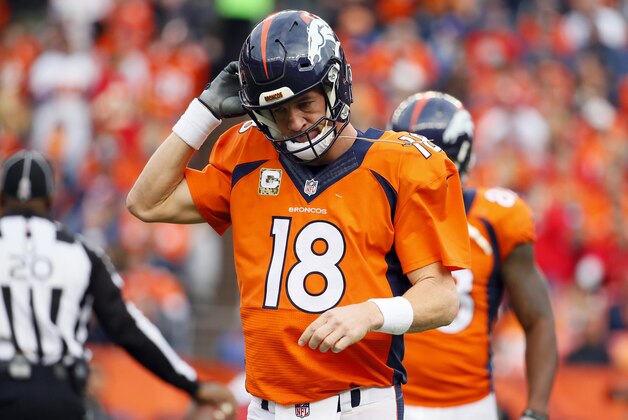 Denver Broncos quarterback Peyton Manning (18) takes off his helmet after throwing an interception during the first half of an NFL football game against the Kansas City Chiefs, Sunday, Nov. 15, 2015, in Denver. (AP Photo/Jack Dempsey)