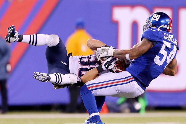 EAST RUTHERFORD, NJ - NOVEMBER 15:  Danny Amendola #80 of the New England Patriots is tackled by Jonathan Casillas #54 of the New York Giants in the final minutes of the game at MetLife Stadium on November 15, 2015 in East Rutherford, New Jersey.  (Photo by Elsa/Getty Images)