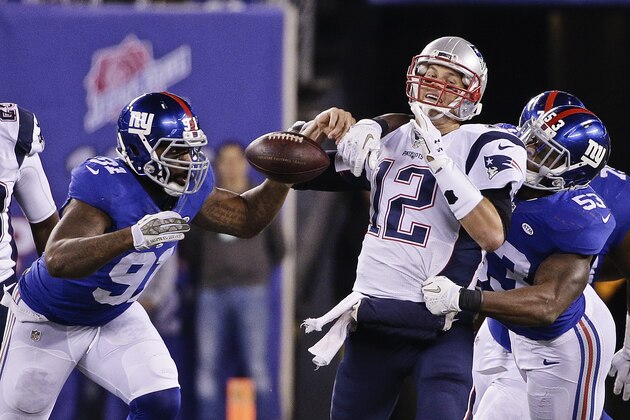 New England Patriots quarterback Tom Brady (12) loses the ball as he is sacked by New England Patriots' Eric Martin (53) and Robert Ayers (91) during the second half of an NFL football game Sunday Nov. 15, 2015, in East Rutherford, N.J. (AP Photo/Julie Jacobson)