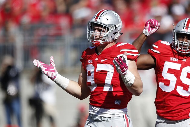 COLUMBUS, OH - OCTOBER 10: Joey Bosa #97 and Tyquan Lewis #59 of the Ohio State Buckeyes celebrate after a sack against the Maryland Terrapins during a game at Ohio Stadium on October 10, 2015 in Columbus, Ohio. The Buckeyes defeated the Terrapins 49-28. (Photo by Joe Robbins/Getty Images)