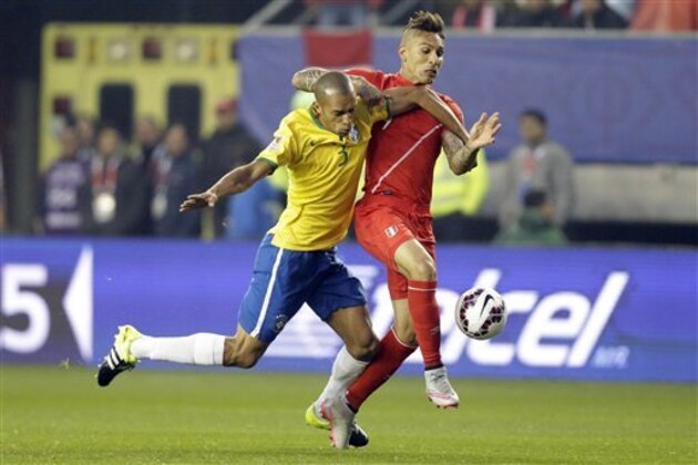 Brazil's Miranda, left, fights for the ball with Peru's Jose Guerrero during a Copa America Group C soccer match at the Bicentenario Germán Becker stadium in Temuco, Chile, Sunday, June 14, 2015. (AP Photo/Jorge Saenz)