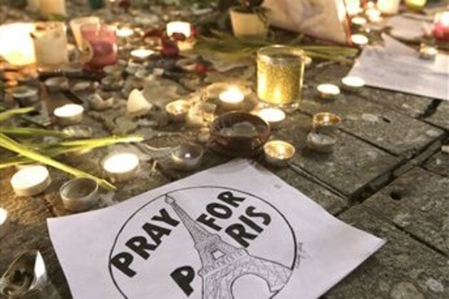 People pay tribute to the victims of the terror attacks in Paris, Monday, Nov. 16, 2015, in Nice, southeastern France. France is urging its European partners to move swiftly to boost intelligence sharing, fight arms trafficking and terror financing, and strengthen border security in the wake of the Paris attacks. (AP Photo/Lionel Cironneau)