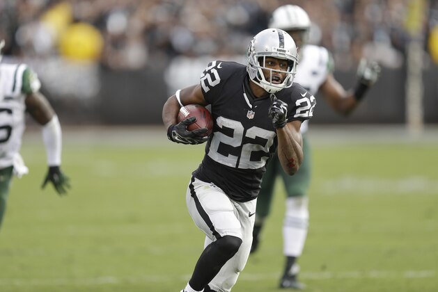 Oakland Raiders running back Taiwan Jones (22) runs toward the end zone to score on a touchdown reception during the second half of an NFL football game against the New York Jets in Oakland, Calif., Sunday, Nov. 1, 2015. (AP Photo/Ben Margot)
