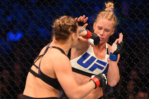 MELBOURNE, AUSTRALIA - NOVEMBER 15:  (L-R) Ronda Rousey of the United States punches Holly Holm of the United States in their UFC women's bantamweight championship bout during the UFC 193 event at Etihad Stadium on November 15, 2015 in Melbourne, Australia. (Photo by Josh Hedges/Zuffa LLC/Zuffa LLC via Getty Images)
