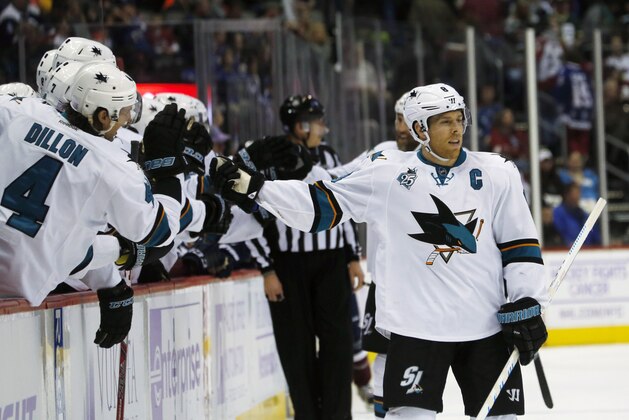 San Jose Sharks center Joe Pavelski, right, is congratulated by defenseman Brenden Dillon after Pavelski's goal against the Colorado Avalanche late in the third period of an NHL hockey game Sunday, Nov. 1, 2015, in Denver. San Jose won 4-3. (AP Photo/David Zalubowski)