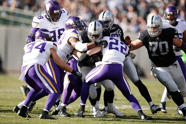 OAKLAND, CA - NOVEMBER 15:  Running back Latavius Murray #28 of the Oakland Raiders is stopped by free safety Harrison Smith #22 of the Minnesota Vikings in the second quarter at O.co Coliseum on November 15, 2015 in Oakland, California.  (Photo by Ezra Shaw/Getty Images)
