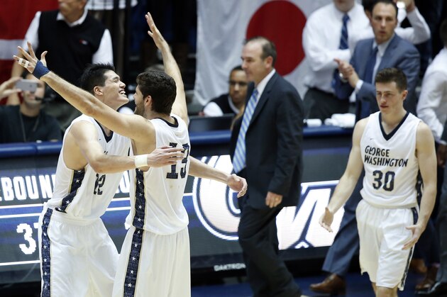 George Washington forward Yuta Watanabe (12) celebrates with guard Patricio Garino (13), with George Washington head coach Mike Lonergan and guard Matt Hart (30) after an NCAA college basketball game against Virginia, Monday, Nov. 16, 2015, in Washington. George Washington won 73-68. (AP Photo/Alex Brandon)