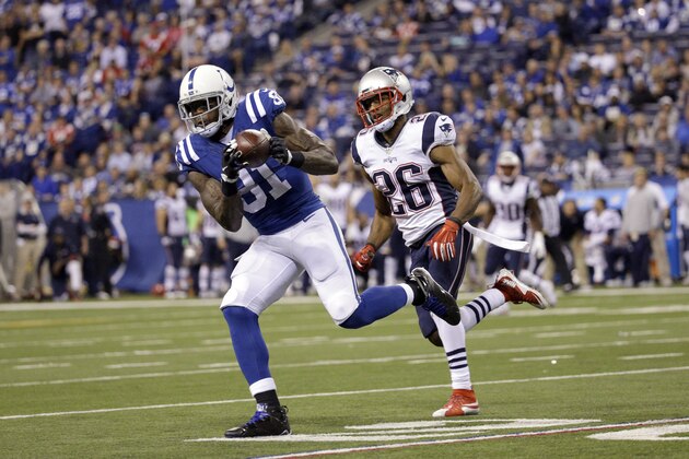 Indianapolis Colts wide receiver Andre Johnson, left, catches a pass as New England Patriots cornerback Logan Ryan defends in the second half of an NFL football game in Indianapolis, Sunday, Oct. 18, 2015. The Patriots won 34-27. (AP Photo/John Minchillo)