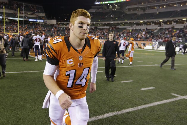 Cincinnati Bengals quarterback Andy Dalton (14) walks off the field following a 10-6 loss to the Houston Texans in the second half of an NFL football game in Cincinnati, Monday, Nov. 16, 2015.  (AP Photo/Michael Conroy)