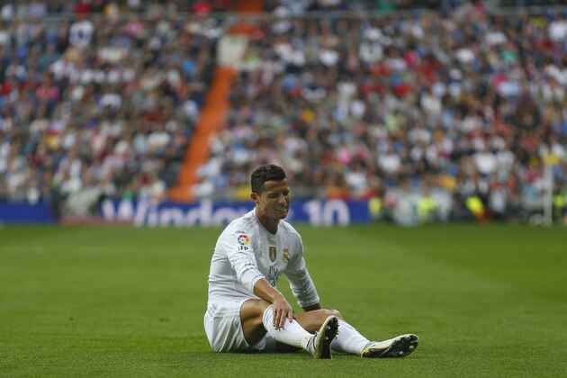 Real Madrid's Cristiano Ronaldo grimaces in pain after being tackled during the Spanish La Liga soccer match between Real Madrid and Las Palmas at the Santiago Bernabeu stadium in Madrid, Saturday, Oct. 31, 2015. Ronaldo scored once in Real Madrid's 3-1 victory. (AP Photo/Francisco Seco)