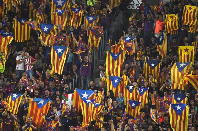 Supporters of Barcelona wave Catalan independentist flags 'Estelada' as one also displays a Basque flag prior to the Spanish Copa del Rey (King's Cup) final football match Athletic Club Bilbao vs FC Barcelona at the Camp Nou stadium in Barcelona on May 30, 2015.   AFP PHOTO/ LLUIS GENE        (Photo credit should read LLUIS GENE/AFP/Getty Images)