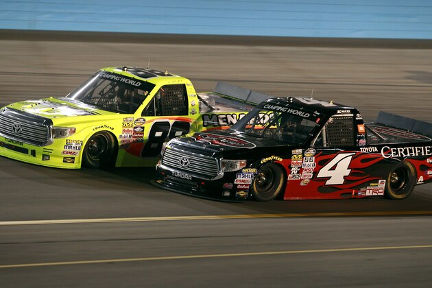 Matt Crafton, left, races Erik Jones (4) through Turn 1 during the NASCAR Trucks auto race at Phoenix International Raceway, Friday, Nov. 13, 2015, in Avondale, Ariz. (AP Photo/Ralph Freso)