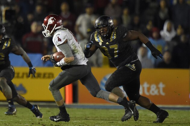UCLA defensive lineman Kenny Clark, right, chases Washington State quarterback Luke Falk during the second half of an NCAA college football game, Saturday, Nov. 14, 2015, in Pasadena, Calif. Washington won 31-27. (AP Photo/Mark J. Terrill)