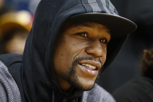 Boxer Floyd Mayweather sits court side in the first half of an NBA preseason basketball game between the Cleveland Cavaliers and the Atlanta Hawks, Wednesday, Oct. 7, 2015, in Cincinnati. The Hawks won 98-96. (AP Photo/John Minchillo)