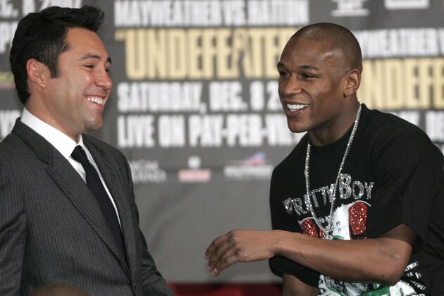 Oscar De La Hoya, left, and Floyd Mayweather Jr., laugh during a news conference after Mayweather beat Ricky Hatton in a WBC welterweight boxing title fight at the MGM Grand hotel-casino in Las Vegas, Saturday, Dec. 8, 2007. Mayweather beat Hatton by knockout in the 10th round. (AP Photo/Jae C. Hong)