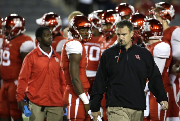 Houston coach Tom Herman watches his team warm up before an NCAA college football game against Memphis Saturday, Nov. 14, 2015, in Houston. (AP Photo/David J. Phillip)