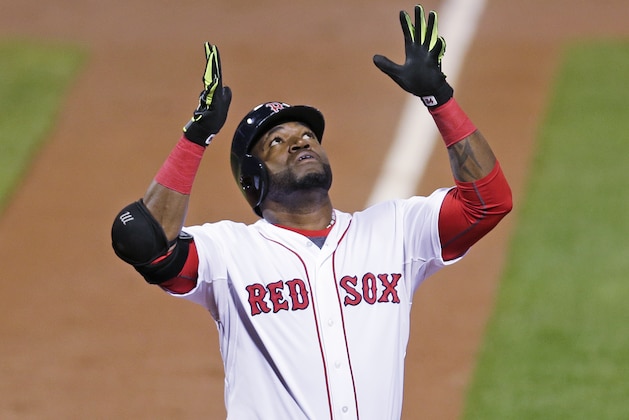 Boston Red Sox designated hitter David Ortiz raises his arms and looks upward as he crosses home plate after a two-run home run during the first inning of a baseball game against the Tampa Bay Rays at Fenway Park in Boston, Thursday, Sept. 24, 2015. (AP Photo/Charles Krupa)