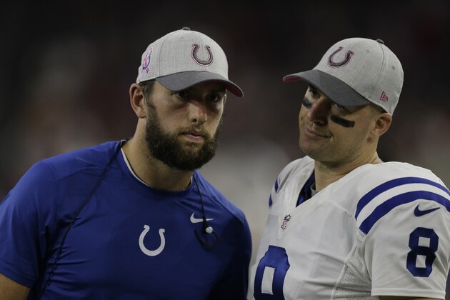 Indianapolis Colts quarterback Matt Hasselbeck (8) talks with injured quarterback Andrew Luck before an NFL football game Thursday, Oct. 8, 2015, in Houston. (AP Photo/Patric Schneider)