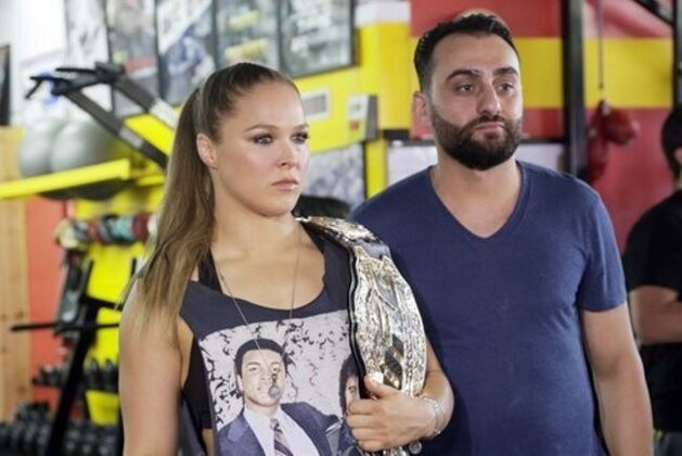 UFC champion Ronda Rousey and her coach Edmond Tarverdyan are seen at a promotional appearance for Rousey’s next title defense in Glendale, Calif., Tuesday, Oct. 27, 2015. Rousey isn’t sharing her opinion of her mother’s sharp criticism of her coach. Tarverdyan also declined to criticize AnnMaria De Mars. Rousey (12-0) will attempt her seventh title defense when she faces former boxing champion Holly Holm at UFC 193 in Melbourne, Australia, on Nov. 15. She has won her previous three fights in 64 combined seconds, establishing herself as the UFC’s most dominant champion and the world’s most famous MMA fighter.(AP Photo/Nick Ut)