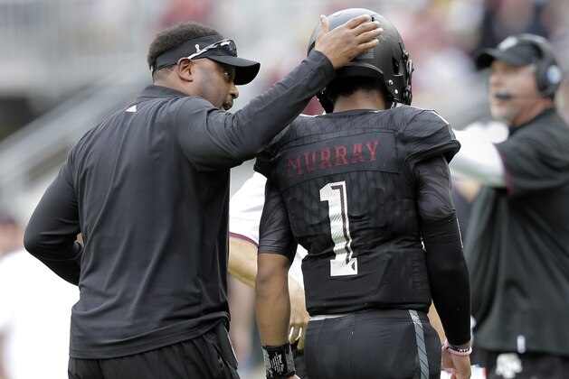 Texas A&M head coach Kevin Sumlin, left, pats quarterback Kyler Murray (1) as he walks off the field during the first half of an NCAA college football game against South Carolina, Saturday, Oct. 31, 2015, in College Station, Texas. (AP Photo/Eric Gay)
