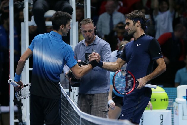Switzerland's Roger Federer, right, shakes hands with Serbia's Novak Djokovic after winning their ATP World Tour Finals tennis match at the O2 Arena in London, England, Tuesday Nov. 17, 2015. (AP Photo/Tim Ireland)