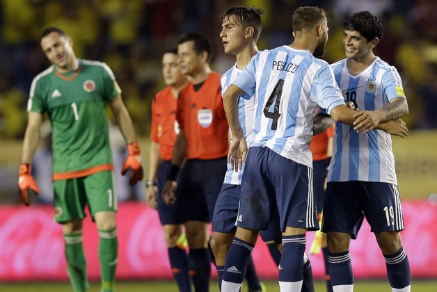 Argentina's Gino Peruzzi (4) and Argentina's Ever Banega, right, celebrate after beating Colombia 1-0 during a 2018 World Cup qualifying soccer match in Barranquilla, Colombia, Tuesday, Nov. 17, 2015. At left is Colombia's goalkeeper David Ospina.(AP Photo/Martin Mejia) Argentina's Gino Peruzzi (4) and Argentina's Ever Banega, right, celebrate after beating Colombia 1-0 during a 2018 World Cup qualifying soccer match in Barranquilla, Colombia, Tuesday, Nov. 17, 2015. At left is Colombia's goalkeeper David Ospina.(AP Photo/Martin Mejia)