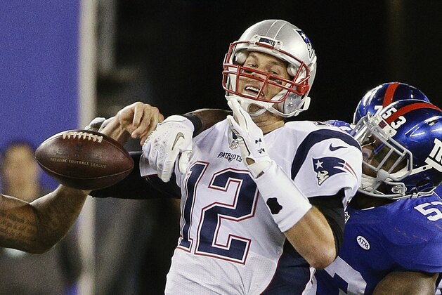New England Patriots quarterback Tom Brady (12) loses the ball as he is sacked by New England Patriots' Eric Martin (53) and Robert Ayers (91) during the second half of an NFL football game Sunday Nov. 15, 2015, in East Rutherford, N.J. (AP Photo/Julie Jacobson)