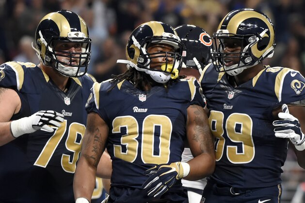 St. Louis Rams' Todd Gurley, center, is congratulated by teammates Robert Havenstein, left, and Jared Cook after scoring on a 6-yard run during the first quarter of an NFL football game against the Chicago Bears, Sunday, Nov. 15, 2015, in St. Louis. (AP Photo/L.G. Patterson)