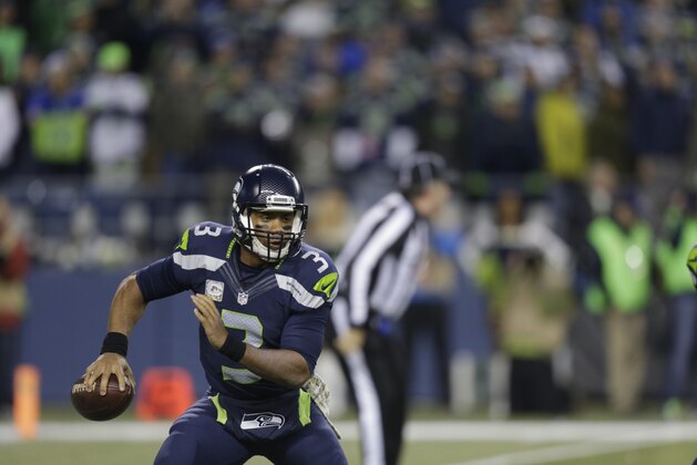 Seattle Seahawks quarterback Russell Wilson looks to pass against the Arizona Cardinals in the first half of an NFL football game, Sunday, Nov. 15, 2015, in Seattle. (AP Photo/Stephen Brashear)