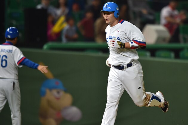 Baseball player Park Byung-Ho of South Korea (R) rounds the bases after hitting a homerun during the men's semifinal game 14 against China at Munhak Baseball Stadium during the 17th Asian Games in Incheon on September 27, 2014. AFP PHOTO / Bay ISMOYO        (Photo credit should read BAY ISMOYO/AFP/Getty Images)