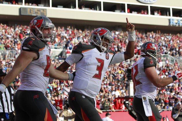 Nov 15, 2015; Tampa, FL, USA; Tampa Bay Buccaneers quarterback Jameis Winston (3) is congratulated by teammates  as he ran the ball in for a touchdown during the fourth quarter against the Dallas Cowboys at Raymond James Stadium. Mandatory Credit: Kim Klement-USA TODAY Sports