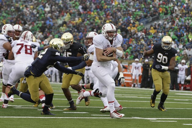 Stanford quarterback Kevin Hogan (8) runs during the first half of an NCAA college football game against Notre Dame Saturday, Oct. 4, 2014, in South Bend, Ind. (AP Photo/Darron Cummings) Stanford quarterback Kevin Hogan (8) runs during the first half of an NCAA college football game against Notre Dame Saturday, Oct. 4, 2014, in South Bend, Ind. (AP Photo/Darron Cummings)