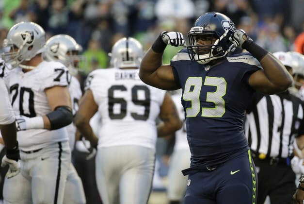 Seattle Seahawks defensive end David King (93) reacts to a play by flexing his muscles in the first half of a preseason NFL football game against the Oakland Raiders, Thursday, Sept. 3, 2015, in Seattle. (AP Photo/Elaine Thompson)