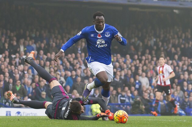 Everton's Romelu Lukaku, top, rounds Sunderland's gaolkeeper Costel Pantilimon to score during the English Premier League soccer match between Everton and Sunderland at Goodison Park Stadium, Liverpool, England, Sunday Nov.1,  2015. (AP Photo/Jon Super)