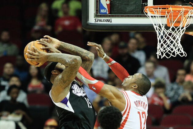 HOUSTON, TX - JANUARY 22:  Dwight Howard #12 of the Houston Rockets defends against DeMarcus Cousins #15 of the Sacramento Kings during the game at the Toyota Center on January 22, 2014 in Houston, Texas. NOTE TO USER: User expressly acknowledges and agrees that, by downloading and or using this photograph, User is consenting to the terms and conditions of the Getty Images License Agreement.  (Photo by Scott Halleran/Getty Images)
