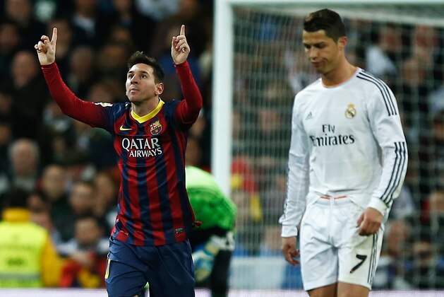 MADRID, SPAIN - MARCH 23:  Lionel Messi of Barcelona celebrates scoring his team's third goal as Cristiano Ronaldo of Real Madrid looks dejected during the La Liga match between Real Madrid CF and FC Barcelona at the Bernabeu on March 23, 2014 in Madrid, Spain.  (Photo by Gonzalo Arroyo Moreno/Getty Images)