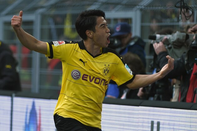 Dortmund's Japanese midfielder Shinji Kagawa celebrates scoring the opening goal during the German first division football Bundesliga match Borussia Dortmund vs FC Schalke 04 on November 8, 2015, 2015 in Dortmund, western Germany. 
AFP PHOTO / PATRIK STOLLARZ

RESTRICTIONS: DURING MATCH TIME: DFL RULES TO LIMIT THE ONLINE USAGE TO 15 PICTURES PER MATCH AND FORBID IMAGE SEQUENCES TO SIMULATE VIDEO. 
==RESTRICTED TO EDITORIAL USE ==
FOR FURTHER QUERIES PLEASE CONTACT THE DFL DIRECTLY AT + 49 69 650050.        (Photo credit should read PATRIK STOLLARZ/AFP/Getty Images)