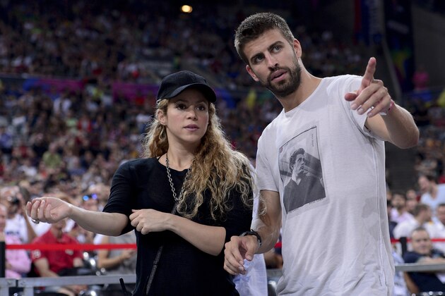 (FILES) FC Barcelona's defender Gerard Pique (R) and his wife Colombian singer Shakira attend the 2014 FIBA World basketball championships quarter-final match Slovenia vs USA at the Palau Sant Jordi arena in Barcelona on September 9, 2014. Colombian pop star Shakira has given birth to a baby boy, named Sasha, her second child overnight with Barcelona footballer Gerard Pique, the celebrity couple annnounced on January 30, 2015. AFP PHOTO / LLUIS GENE        (Photo credit should read JOSEP LAGO/AFP/Getty Images)