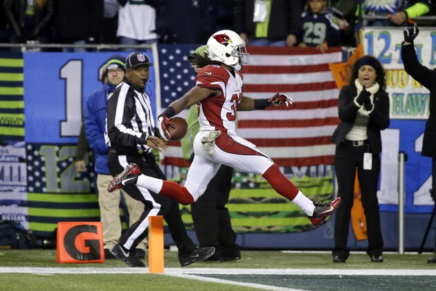 Arizona Cardinals running back Andre Ellington leaps into the end zone for a touchdown against the Seattle Seahawks during the second half of an NFL football game, Sunday, Nov. 15, 2015, in Seattle. (AP Photo/Elaine Thompson)