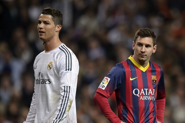 Barcelona's Argentinian forward Lionel Messi (R) stands past Real Madrid's Portuguese forward Cristiano Ronaldo during the 'El clasico' Spanish League football match Real Madrid vs Barcelona at the Santiago Bernabeu stadium in Madrid on March 23, 2014. Barcelona won 4-3.    AFP PHOTO/ DANI POZO        (Photo credit should read DANI POZO/AFP/Getty Images)