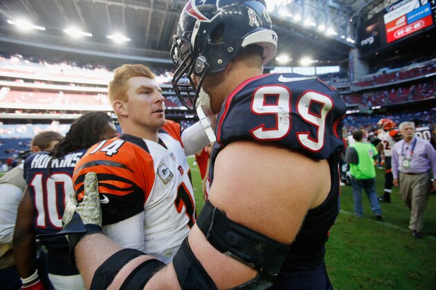 HOUSTON, TX - NOVEMBER 23:  Andy Dalton #14 of the Cincinnati Bengals greets  J.J. Watt #99 of the Houston Texans on the field after the Bengals defeated the Texans 22-13 at NRG Stadium on November 23, 2014 in Houston, Texas.  (Photo by Scott Halleran/Getty Images)