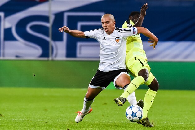 Valencia's Sofiane Feghouli, left, challenges Gent's Nana Asare during the Champions League Group H soccer match between KAA Gent and Valencia CF at the Ghelamco Arena in Ghent, Belgium, Wednesday, Nov. 4, 2015. (AP Photo/Geert Vanden Wijngaert) Valencia's Sofiane Feghouli, left, challenges Gent's Nana Asare during the Champions League Group H soccer match between KAA Gent and Valencia CF at the Ghelamco Arena in Ghent, Belgium, Wednesday, Nov. 4, 2015. (AP Photo/Geert Vanden Wijngaert)