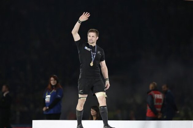 New Zealand's captain Richie McCaw waves after getting his winners medal after the Rugby World Cup final between New Zealand and Australia at Twickenham Stadium in London,  Saturday, Oct. 31, 2015.  The All Blacks won 34-17. (AP Photo/Tim Ireland)