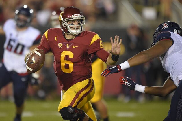 Southern California quarterback Cody Kessler, left, tries to hold off Arizona defensive lineman Reggie Gilbert during the first half of an NCAA college football game, Saturday, Nov. 7, 2015, in Los Angeles. (AP Photo/Mark J. Terrill)