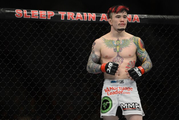 December 14, 2013; Sacramento, CA, USA; Scott Jorgensen (red gloves) fights Zach Makovsky (blue gloves) during the flyweight bout of the UFC on FOX 9 at Sleep Train Arena. Mandatory Credit: Kyle Terada-USA TODAY Sports