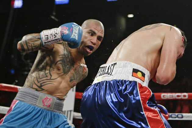 Miguel Cotto, left, of Puerto Rico, punches Daniel Geale, of Australia, during the second round of a boxing match Saturday, June 6, 2015, in New York. (AP Photo/Frank Franklin II)