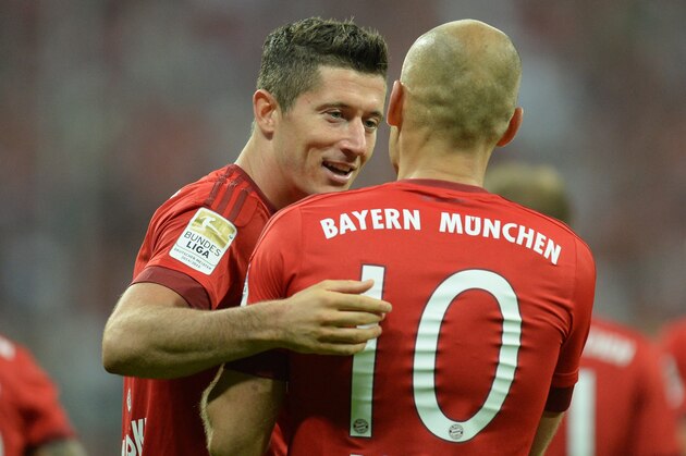 Bayern Munich's Dutch midfielder Arjen Robben (R) and Bayern Munich's Polish striker Robert Lewandowski celebrates scoring the 2-0 goal during the German first division Bundesliga football match FC Bayern Munich vs Hamburger SV at the Allianz Arena in Munich, southern Germany, on August 14, 2015. The match is the first of the 2015/2016 season. AFP PHOTO / CHRISTOF STACHE

RESTRICTIONS: DURING MATCH TIME: DFL RULES TO LIMIT THE ONLINE USAGE TO 15 PICTURES PER MATCH AND FORBID IMAGE SEQUENCES TO SIMULATE VIDEO. 
== RESTRICTED TO EDITORIAL USE ==
FOR FURTHER QUERIES PLEASE CONTACT DFL DIRECTLY AT + 49 69 650050.        (Photo credit should read CHRISTOF STACHE/AFP/Getty Images)
