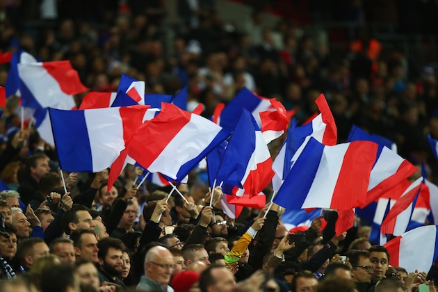 LONDON, ENGLAND - NOVEMBER 17:  French supporters wave the national flags prior to the International Friendly match between England and France at Wembley Stadium on November 17, 2015 in London, England.  (Photo by Clive Rose/Getty Images)